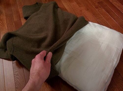 Covering a pillow with a sweater